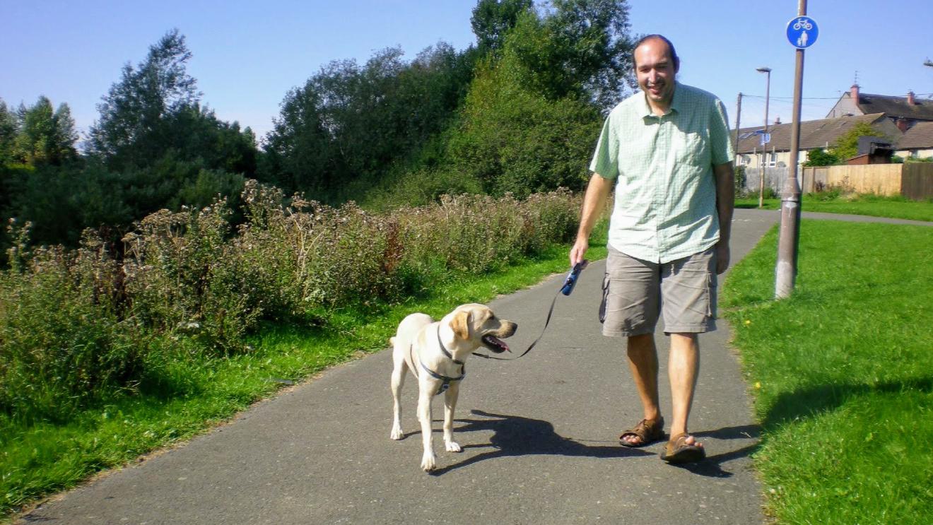 Dog and handler walking side by side